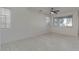 Bright living room boasts tile floors, multiple windows, and a modern ceiling fan at 2254 E University Dr # 4, Mesa, AZ 85213