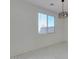 Bright living room with neutral walls, modern light fixture, and large window at 2254 E University Dr # 4, Mesa, AZ 85213