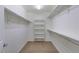 A spacious walk-in closet featuring built-in shelving and ample storage on the rods, along with carpeted floor at 2254 E University Dr # 4, Mesa, AZ 85213