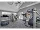 An open gym with modern exercise machines, carpeted floors, and a ceiling fan at 2333 E Southern Ave # 2016, Tempe, AZ 85282