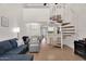 Cozy living room with a spiral staircase leading to an upper level and views to the kitchen and dining areas at 2333 E Southern Ave # 2016, Tempe, AZ 85282