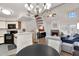 Open-concept living space showcasing a kitchen, spiral staircase, fireplace, and comfortable furnishings at 2333 E Southern Ave # 2016, Tempe, AZ 85282
