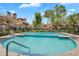 Community pool with blue tile accents surrounded by well-maintained landscaping and multi-story condo buildings at 2333 E Southern Ave # 2016, Tempe, AZ 85282