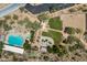 A serene aerial view showcasing a community pool, playground, sand volleyball court and picnic area surrounded by lush trees at 2638 W Sat Nam Way, Phoenix, AZ 85086