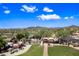 Beautiful aerial view of the community park, highlighting the playground, picnic area and desert landscape with distant mountain views at 2638 W Sat Nam Way, Phoenix, AZ 85086