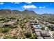 Aerial view of a neighborhood surrounded by mountains and desert landscape on a sunny day at 2638 W Sat Nam Way, Phoenix, AZ 85086