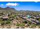 Aerial view of a desert neighborhood, blue sky, and mountain views at 2638 W Sat Nam Way, Phoenix, AZ 85086