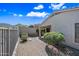 Landscaped backyard with a covered patio and stone accents, enclosed by desert landscaping and block wall at 2638 W Sat Nam Way, Phoenix, AZ 85086