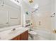 Traditional bathroom featuring a single sink vanity, and a shower/tub combo with decorative tile surround at 2638 W Sat Nam Way, Phoenix, AZ 85086