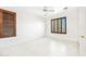 Bright bedroom with shutters on the windows, a ceiling fan and light tile floors at 2638 W Sat Nam Way, Phoenix, AZ 85086