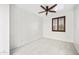 This bedroom boasts modern tile floors, a ceiling fan, and a window with beautiful wooden shutters at 2638 W Sat Nam Way, Phoenix, AZ 85086