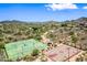 Beautiful aerial view of the community tennis and basketball courts, set against a desert landscape with mountain views at 2638 W Sat Nam Way, Phoenix, AZ 85086