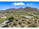 An aerial view of the community park, featuring a playground, sports courts, and desert landscape with mountain views at 2638 W Sat Nam Way, Phoenix, AZ 85086