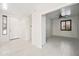 Bright entryway with white tile flooring and a view into the adjacent living space with shutters at 2638 W Sat Nam Way, Phoenix, AZ 85086