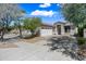 Inviting one-story beige home with a two-car garage and desert landscaping at 2638 W Sat Nam Way, Phoenix, AZ 85086