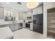 Modern kitchen features stainless steel appliances, gray cabinetry, and a black refrigerator at 2638 W Sat Nam Way, Phoenix, AZ 85086
