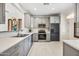 Renovated kitchen with stainless steel appliances, stylish gray cabinetry, and tile flooring at 2638 W Sat Nam Way, Phoenix, AZ 85086