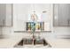 Modern kitchen features stainless steel sink and countertops, with a view into another room at 2638 W Sat Nam Way, Phoenix, AZ 85086