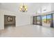 Bright, open-concept living room with tile flooring, and a decorative chandelier, offering abundant space and natural light at 2638 W Sat Nam Way, Phoenix, AZ 85086