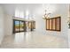 Bright living room with neutral walls, tile floors, large windows, and a chandelier at 2638 W Sat Nam Way, Phoenix, AZ 85086