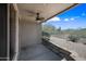 Covered outdoor patio with ceiling fan, and landscaped backyard with gravel and vegetation at 2638 W Sat Nam Way, Phoenix, AZ 85086