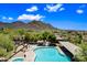 Inviting community pool with a clear view of the mountains, desert landscaping, and plenty of room to relax at 2638 W Sat Nam Way, Phoenix, AZ 85086