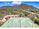 A high aerial view showcasing tennis courts, set in a desert community with mountain views at 2638 W Sat Nam Way, Phoenix, AZ 85086