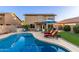 Resort style backyard with sparkling pool, lush landscaping, and lounge chairs for relaxation at 3031 S Cortland --, Mesa, AZ 85212