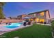 Expansive backyard with sparkling pool, lush artificial turf, and patio area for ultimate outdoor enjoyment and entertaining at 3031 S Cortland --, Mesa, AZ 85212