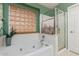 Bright bathroom featuring a soaking tub, glass-enclosed shower and modern desert decor at 3031 S Cortland --, Mesa, AZ 85212