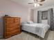 Cozy bedroom with neutral walls, plush carpeting, and a traditional wooden dresser at 3031 S Cortland --, Mesa, AZ 85212