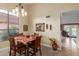 Dining room with natural light, wooden table and chairs, with views into the yard at 3031 S Cortland --, Mesa, AZ 85212