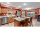 Bright kitchen with wooden cabinets, stainless steel appliances, a center island, and a view of the backyard at 3031 S Cortland --, Mesa, AZ 85212