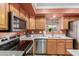 Modern kitchen featuring stainless steel appliances, wooden cabinets, and a bright countertop, offering a functional and stylish cooking space at 3031 S Cortland --, Mesa, AZ 85212
