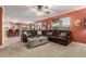 Spacious living area featuring a large leather sofa, carpet, and open kitchen view at 3031 S Cortland --, Mesa, AZ 85212