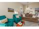 Cozy sitting room featuring two green accent chairs, sofa, and neutral color scheme at 3031 S Cortland --, Mesa, AZ 85212