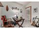 Home office featuring a modern desk, wooden shelves, natural light, and comfortable seating at 3031 S Cortland --, Mesa, AZ 85212