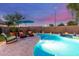 Backyard featuring a sparkling pool, covered patio, lounge chairs and well-manicured landscaping at 3031 S Cortland --, Mesa, AZ 85212
