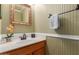 Charming powder room with light green beadboard and decorative mirror at 3031 S Cortland --, Mesa, AZ 85212
