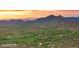 Panoramic aerial view of a desert community with mountains and a colorful sunset at 30600 N Pima Rd # 61, Scottsdale, AZ 85266