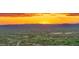 Expansive aerial view of a desert community at sunset featuring golf course, homes and mountain views at 30600 N Pima Rd # 61, Scottsdale, AZ 85266