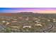 Expansive aerial view showcases a luxury home in a desert community with mountain views at 30600 N Pima Rd # 61, Scottsdale, AZ 85266