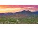 Scenic aerial view of a desert community with mountain views under a colorful sunset at 30600 N Pima Rd # 61, Scottsdale, AZ 85266