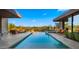 Luxurious backyard with a long, elegant pool surrounded by lounge seating and desert landscaping at 30600 N Pima Rd # 61, Scottsdale, AZ 85266