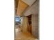 Wet bar that features custom wood cabinetry, stone countertops, space for bar stools, and glass shelving at 30600 N Pima Rd # 61, Scottsdale, AZ 85266