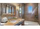 Elegant bathroom featuring a tub with shower, a decorative mirror, and a neutral color palette at 30600 N Pima Rd # 61, Scottsdale, AZ 85266