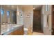 Well-lit bathroom featuring a stone countertop and tiled shower at 30600 N Pima Rd # 61, Scottsdale, AZ 85266