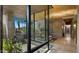 Indoor courtyard with lush landscaping, a water feature, floor-to-ceiling windows, and a light stone floor at 30600 N Pima Rd # 61, Scottsdale, AZ 85266