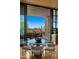 Bright dining area featuring a glass table and seating with a view of the outdoor desert landscape at 30600 N Pima Rd # 61, Scottsdale, AZ 85266