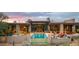 Stunning modern home with a pool, fire pit, and inviting outdoor living spaces at sunset at 30600 N Pima Rd # 61, Scottsdale, AZ 85266
